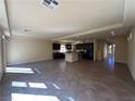 Spacious open concept living area with a large kitchen, tile floors and recessed lighting at 6093 Crown Palms Ave, Las Vegas, NV 89139