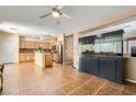Bright, open-concept kitchen with stainless steel appliances, tile flooring, and a kitchen island at 6329 Orange Hue St, North Las Vegas, NV 89031
