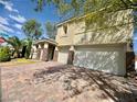 Beautiful two-story home shows a tile roof, desert landscaping, and a three-car garage at 640 House Blend Ln, Henderson, NV 89052