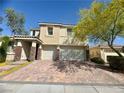 Charming two-story home boasts a tile roof, brick driveway, and a three-car garage at 640 House Blend Ln, Henderson, NV 89052