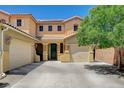 Inviting two-story home featuring a well-maintained lawn, a tile roof, and a spacious driveway with an attached garage at 6409 Sea Swallow St, North Las Vegas, NV 89084