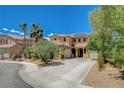 Two-story home with desert landscaping, mature trees, and spacious driveway, offering a welcoming curb appeal at 6409 Sea Swallow St, North Las Vegas, NV 89084
