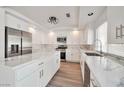 Stylish kitchen with white cabinets, stainless steel appliances, marble countertops, and a kitchen island at 6509 Alpine Winter Ct, Las Vegas, NV 89149