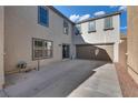 Spacious backyard with a patio area and access to the garage, perfect for outdoor activities at 680 Moonlight Stroll St, Henderson, NV 89002