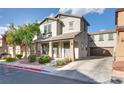 Charming two-story home featuring well-maintained landscaping and a welcoming front porch at 680 Moonlight Stroll St, Henderson, NV 89002