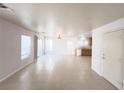 Spacious open-concept living room featuring tile flooring, recessed lighting, and backyard access at 7249 Old Glory St, Las Vegas, NV 89148