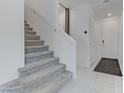 Carpeted staircase with white walls and handrail leading to the upper level, enhanced by bright, neutral decor at 7256 Saxby Ave, Las Vegas, NV 89113