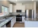 Well-lit kitchen featuring granite countertops, stainless steel appliances, and ample cabinetry at 740 White Grotto St, Las Vegas, NV 89138