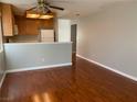 View of the wood floors and a neutral color scheme in the open concept dining area and kitchen at 7614 Isley Ave, Las Vegas, NV 89147