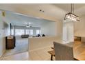 Bright dining area with rustic wood table, decorative lighting, and easy access to living room at 7649 Broadwing Dr, North Las Vegas, NV 89084