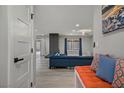 Home entryway featuring a bench seat, modern lighting, and a partial view into the living space at 823 Cherry Dr, Henderson, NV 89002