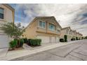 Attractive townhome exterior with a two-car garage, manicured landscaping, and a well-maintained facade at 8801 Duncan Barrel Ave # 103, Las Vegas, NV 89178