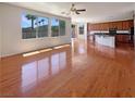 Spacious living area features hardwood floors and large windows for ample natural light at 9319 Bronze River Ave, Las Vegas, NV 89149