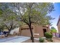 Two-story home showcasing an attached two-car garage, desert landscaping, and blue car at 9629 Toy Soldier St, Las Vegas, NV 89178