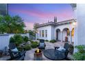 Beautifully landscaped backyard patio with comfortable seating and a cozy fire pit for outdoor enjoyment at 10717 Beringer Dr, Las Vegas, NV 89144