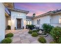Inviting front entrance with stone pathway, manicured landscaping, and a decorative wreath on the door at 10717 Beringer Dr, Las Vegas, NV 89144