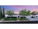 Charming single-story home with manicured lawn, mature trees, and a three-car garage at 10717 Beringer Dr, Las Vegas, NV 89144
