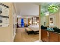 Comfortable hotel suite bedroom featuring a king bed, lounge seating, and a stylish wet bar at 125 E Harmon Ave # 717, Las Vegas, NV 89109