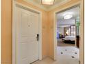 Suite entryway with a white door, textured walls, and a glimpse of the bedroom at 125 E Harmon Ave # 717, Las Vegas, NV 89109