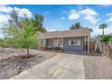 Charming single story home with gray exterior, brick detail, drought landscaping, and mature tree at 1320 Wengert Ave, Las Vegas, NV 89104