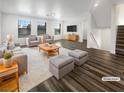 Bright living room featuring modern furniture, wood floors, and multiple sunny windows at 148 Campbelltown Ave, Henderson, NV 89015