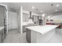Modern kitchen with gray cabinetry, stainless appliances, and a large island at 174 Cabo Cruces Dr, Henderson, NV 89011