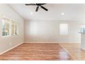 A spacious living room with a ceiling fan and large windows offering plenty of natural light at 2833 Swanson Ave, North Las Vegas, NV 89086