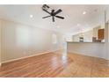 Bright living room featuring wood-look flooring and neutral walls, ceiling fan and natural light at 2833 Swanson Ave, North Las Vegas, NV 89086