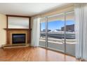 Close-up of hardwood floor living room with fireplace and sliding glass doors to a balcony at 2857 Paradise Rd # 802, Las Vegas, NV 89109