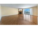 Bright living room with hardwood flooring, a fireplace, and large sliding glass doors with access to balcony at 2857 Paradise Rd # 802, Las Vegas, NV 89109