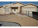 Single story home with desert landscaping and tan exterior at 2920 Malibou Ave, Pahrump, NV 89048