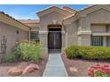 A close-up of the front entrance with decorative landscaping and a well-maintained walkway at 2929 Haddon Dr, Las Vegas, NV 89134