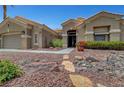 Inviting single-story home featuring a meticulously landscaped front yard with rock accents and a garden at 2929 Haddon Dr, Las Vegas, NV 89134