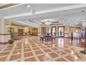 Elegant lobby with decorative tile flooring, recessed lighting, seating, and front desk at 30 Strada Di Villaggio # 306, Henderson, NV 89011