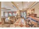 Comfortable lounge area with seating, bar, decorative lighting, and a stylish decor at 30 Strada Di Villaggio # 306, Henderson, NV 89011