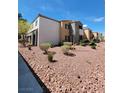 Exterior shot of the condo building featuring manicured desert landscaping at 3151 Soaring Gulls Dr # 2101, Las Vegas, NV 89128