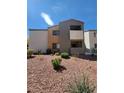 Exterior view of condo building with colorful landscaping and visible air conditioning units at 3151 Soaring Gulls Dr # 2101, Las Vegas, NV 89128