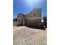 Charming two-story home with a two-car garage and beautifully paved driveway at 369 Stone Fly Rd, North Las Vegas, NV 89032