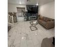 Cozy living room with fireplace and marble flooring throughout the lower level at 369 Stone Fly Rd, North Las Vegas, NV 89032