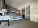 Bright bedroom with a patterned bedspread, modern lamps, and access to a walk-in closet at 3722 Las Vegas Blvd # 2709, Las Vegas, NV 89158