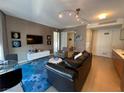 Open-concept living room featuring sleek furniture, modern lighting, and a wall-mounted TV at 3722 Las Vegas Blvd # 2709, Las Vegas, NV 89158