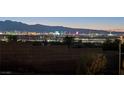 Wide Las Vegas skyline view at night featuring colorful lights, casinos, and distant mountains at 392 Waterwheel Falls Dr, Henderson, NV 89015