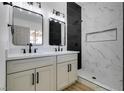 Modern bathroom featuring a double sink vanity, updated fixtures, and tiled shower at 4255 Breezy Point Ln, Las Vegas, NV 89115