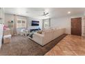 Bright living room with a large sofa, natural light, ceiling fan, and neutral-toned walls at 508 Purcell Dr, Las Vegas, NV 89107