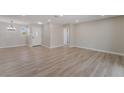 Spacious living room with wood-look floors, neutral paint, and recessed lighting at 5245 Hillman Ave, Las Vegas, NV 89142