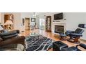 Cozy living room features a fireplace, hardwood floors, and modern furnishings at 5401 Bugle Way # 103, Las Vegas, NV 89108