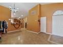The entryway showcases high ceilings, stylish tile flooring, and leads into the open-concept kitchen, and living areas at 619 Zalataia Way, North Las Vegas, NV 89031
