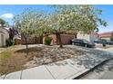Charming single-story home with a well-maintained lawn, mature trees, and a two-car garage, situated in a friendly neighborhood at 619 Zalataia Way, North Las Vegas, NV 89031