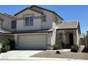 Charming two-story home with a two-car garage, complemented by desert landscaping at 7282 Quarterhorse Ln, Las Vegas, NV 89148