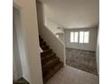 View of the living room with carpet flooring and natural light from multiple windows at 7282 Quarterhorse Ln, Las Vegas, NV 89148